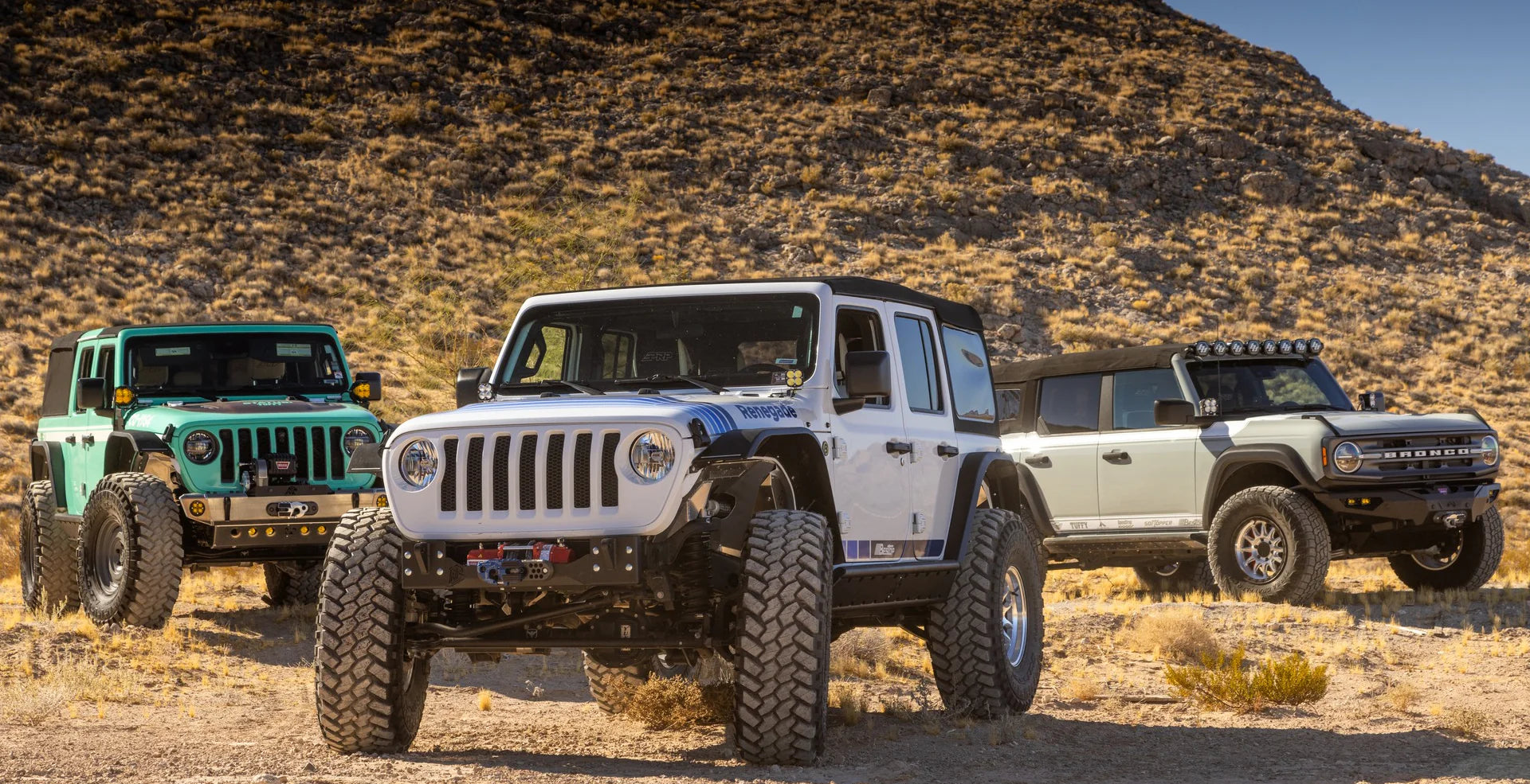 Jeep Wrangler JL 4-Door fitted with soft top on rugged off-road terrain